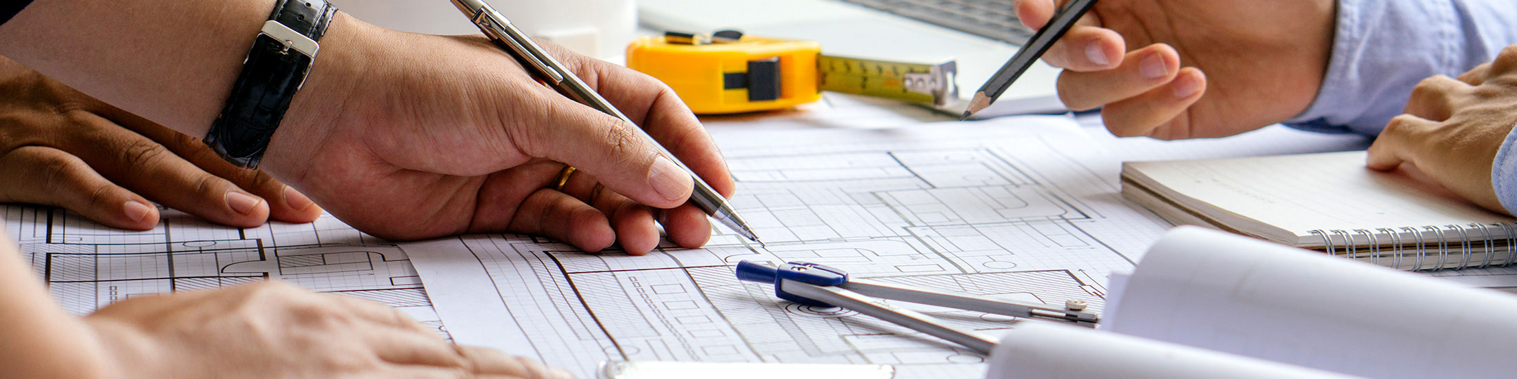 Hands pointing out elements on network diagram