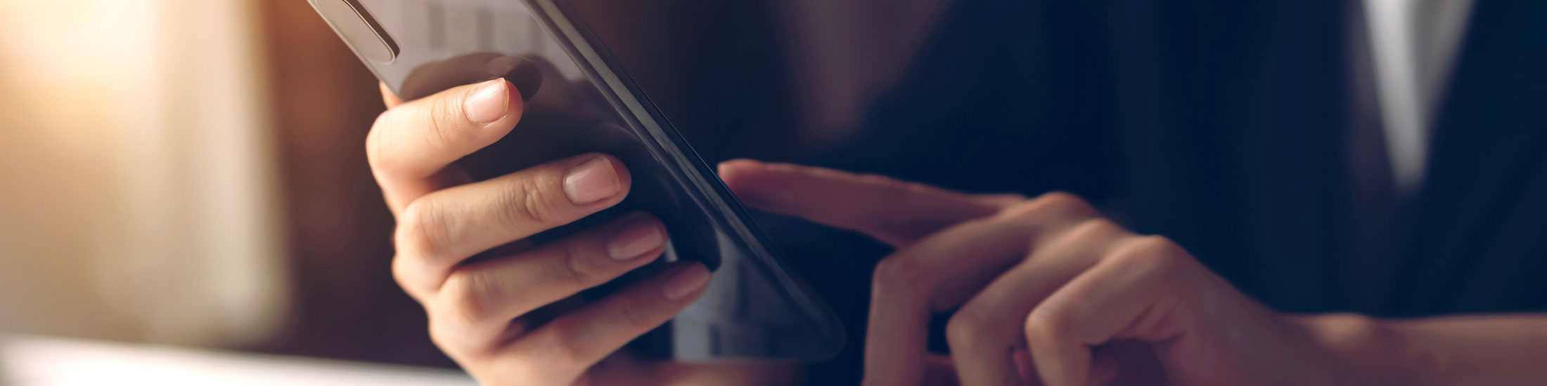 close-up of hands using a mobile phone